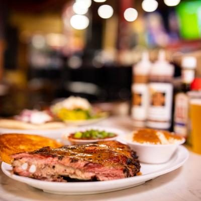 hickory smoked ribs with two bottles of bbq sauce with a label for southern grill jacksonville
